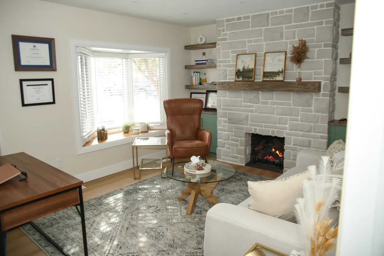 A welcoming view into a KDW Counselling therapy room with a fireplace and comfortable seating.